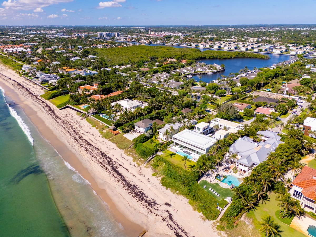 Luxury waterfront homes along a coastal town shoreline